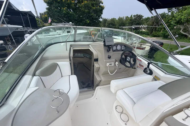 Slide: The Image of 2007 Sea Ray 240 Sundancer boat interior with helm, seating, and navigation equipment. - 19