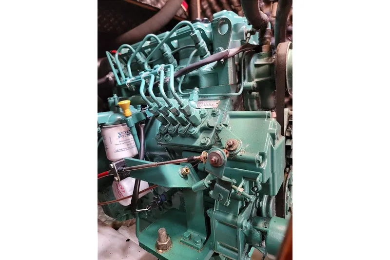 Slide: The Image of Engine of a 2003 Beneteau 423 sailboat, featuring detailed mechanical components. - 13