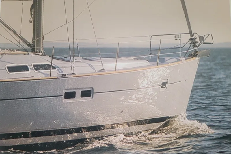 Slide: The Image of 2003 Beneteau 423 sailboat cruising on open water, side view. - 14