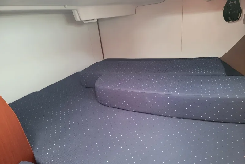 Slide: The Image of Interior cabin of a 2003 Beneteau 423 yacht with cushioned bedding. - 16
