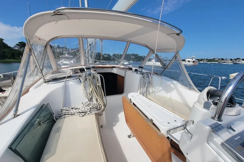 Slide: The Image of Cockpit of a 2003 Beneteau 423 sailboat, featuring seating and navigation equipment. - 20