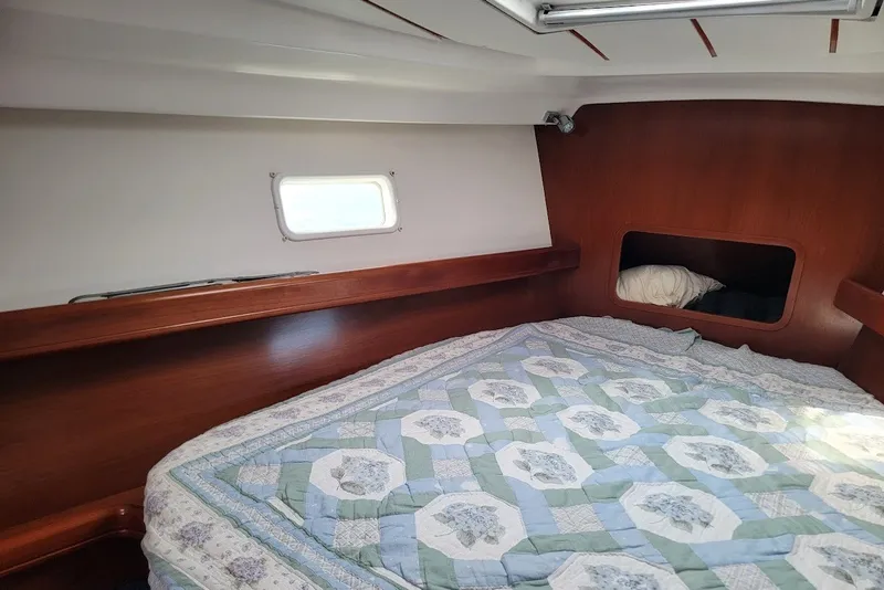 Slide: The Image of Cozy cabin interior of 2003 Beneteau 423 sailboat with quilted bedding. - 9