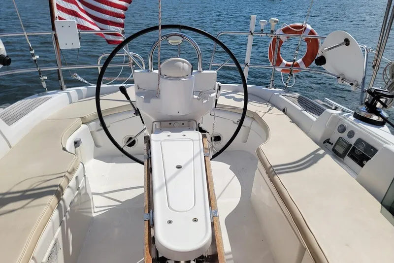 Slide: The Image of Cockpit of 2003 Beneteau 423 sailboat with steering wheel and American flag. - 3