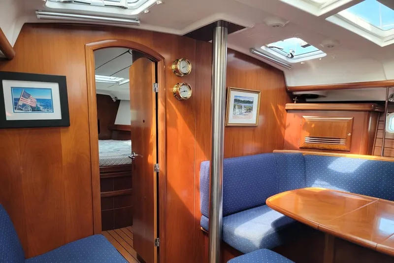 Slide: The Image of Interior of 2003 Beneteau 423 yacht with wood finish and blue seating. - 8