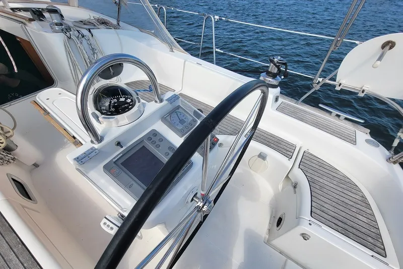 Slide: The Image of Cockpit of 2003 Beneteau 423 sailboat with steering wheel and navigation instruments. - 19