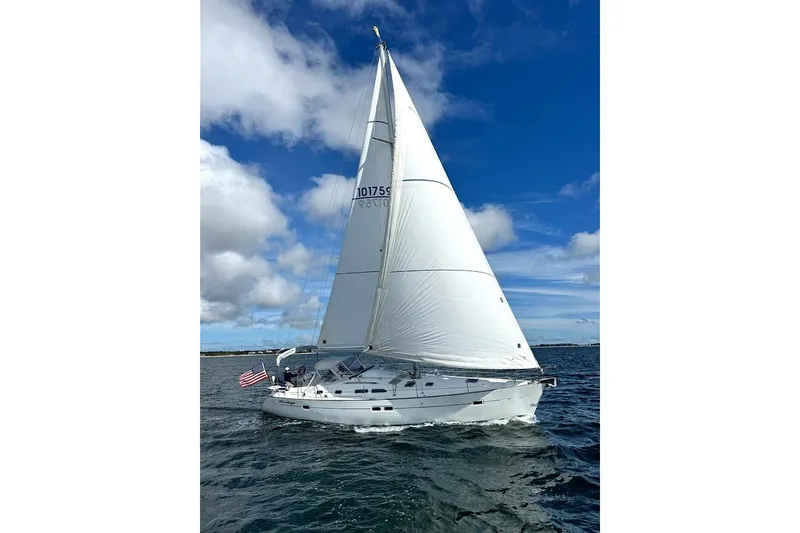 Slide: The Image of Sailing yacht Beneteau 423 (2003) on open water under clear blue skies. - 24