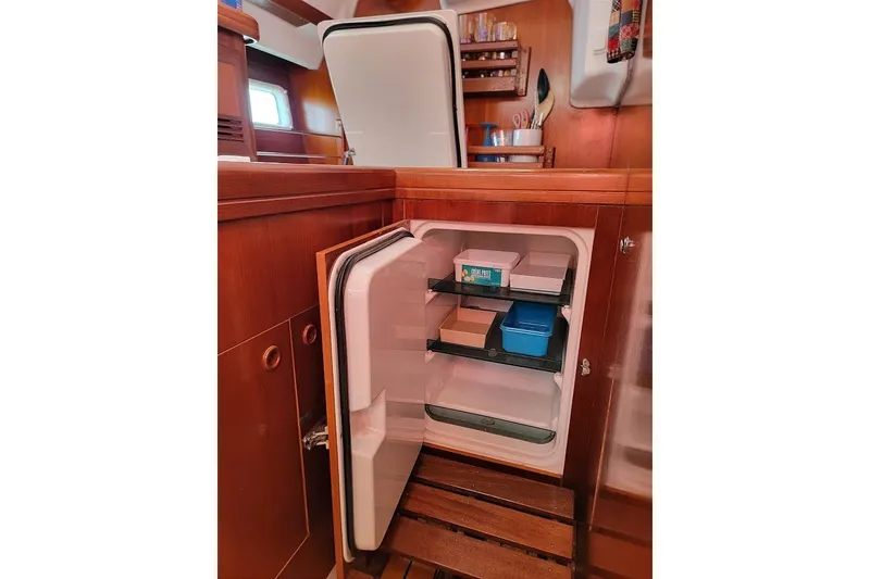 Slide: The Image of Open refrigerator in the galley of a 2003 Beneteau 423 sailboat. - 31