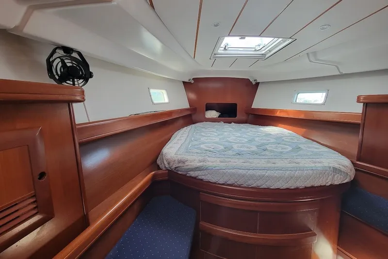 Slide: The Image of Luxurious cabin interior of 2003 Beneteau 423 yacht with cozy bed and wooden finish. - 2