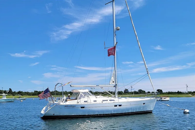 Slide: The Image of 2003 Beneteau 423 sailboat on calm water under a clear blue sky. - 21