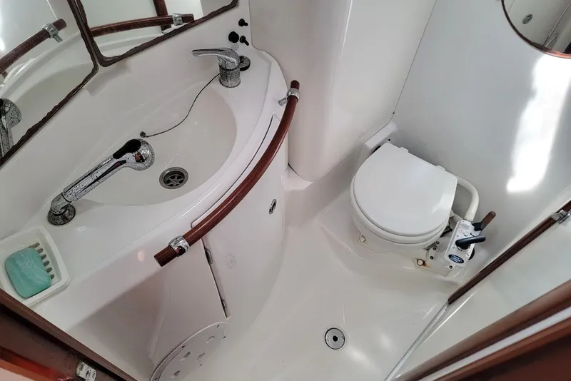 Slide: The Image of Bathroom interior of 2003 Beneteau 423 yacht, featuring sink and toilet. - 17