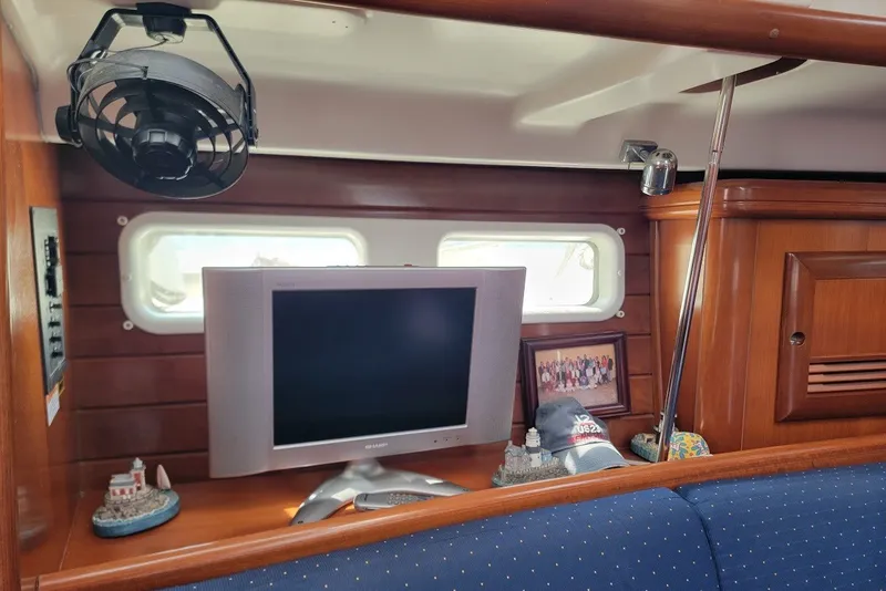 Slide: The Image of Interior of 2003 Beneteau 423 yacht with TV, fan, and decor items. - 23