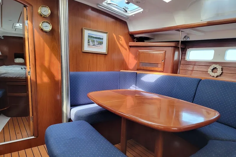 Slide: The Image of Interior of 2003 Beneteau 423 yacht with wooden table and blue seating. - 28
