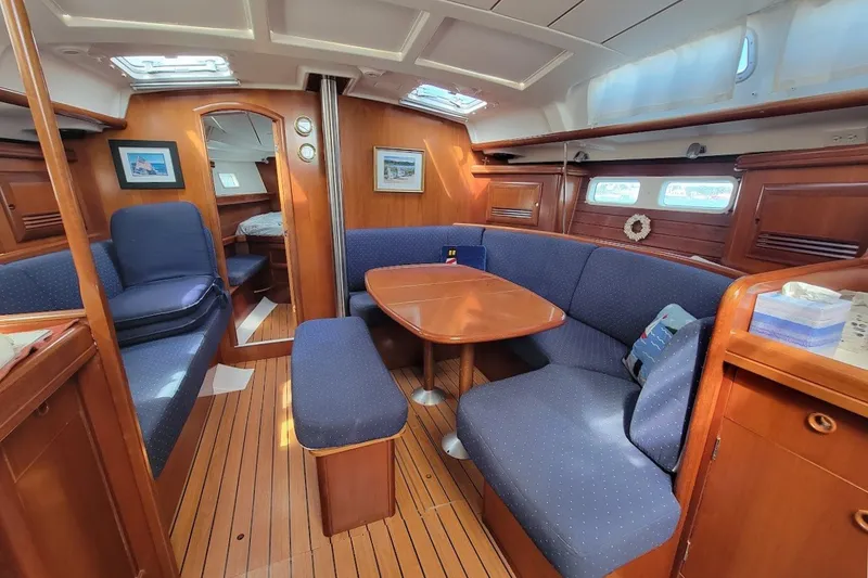 Slide: The Image of Interior of a 2003 Beneteau 423 yacht with cozy seating and wooden finishes. - 22