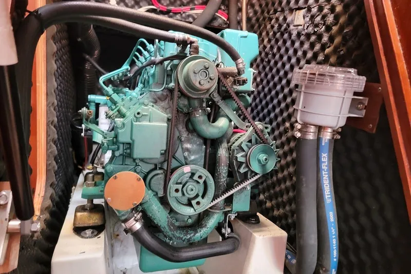 Slide: The Image of Engine compartment of a 2003 Beneteau 423 sailboat, featuring a marine diesel engine. - 12