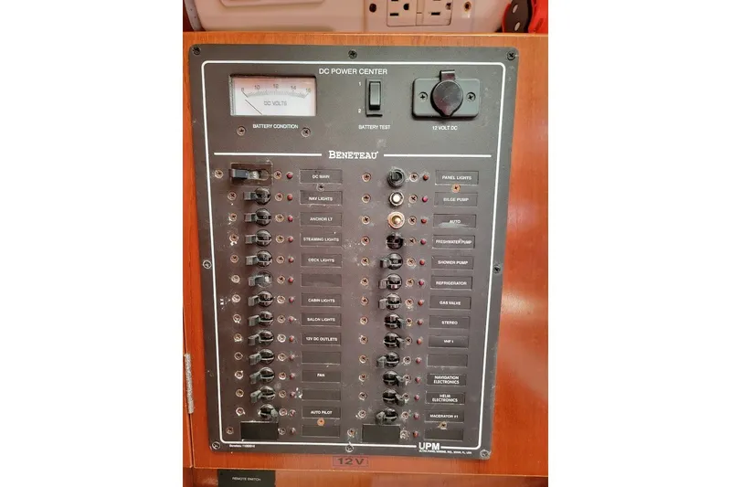 Slide: The Image of Electrical panel of a 2003 Beneteau 423 sailboat, featuring various switches and controls. - 27