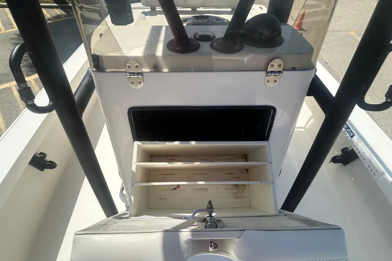 Slide: The Image of 2013 Pathfinder 2300 HPS boat console with open storage compartments and fishing rod holders. - 9