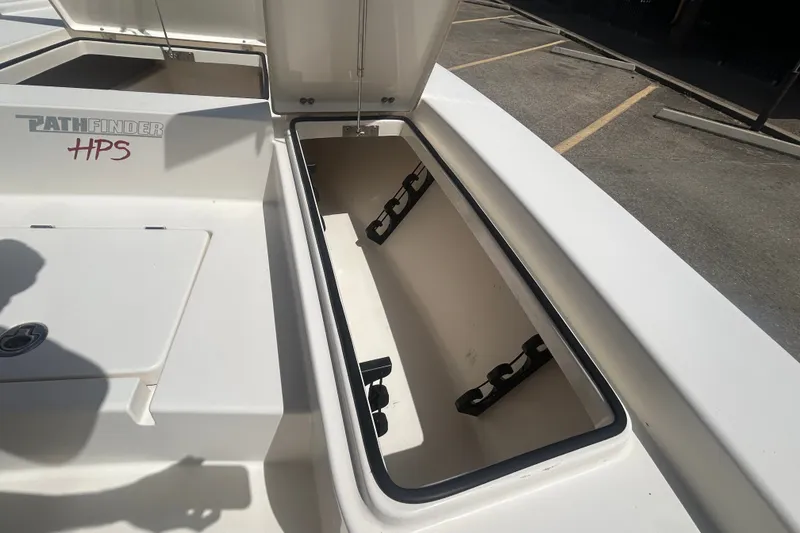 Slide: The Image of Open storage compartment on a 2013 Pathfinder 2300 HPS boat, showing interior details. - 6
