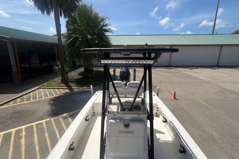 Slide: The Image of 2013 Pathfinder 2300 HPS boat parked outdoors under clear blue sky. - 8