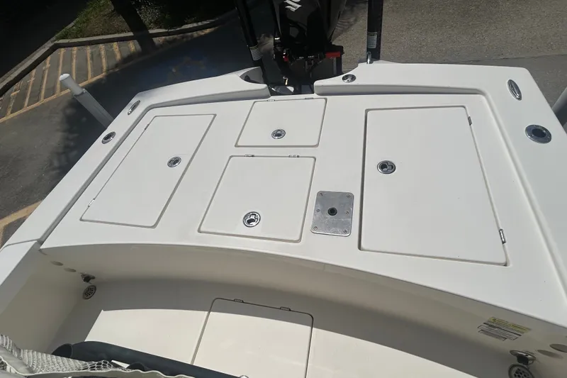 Slide: The Image of 2013 Pathfinder 2300 HPS boat deck with storage compartments and clean white finish. - 18
