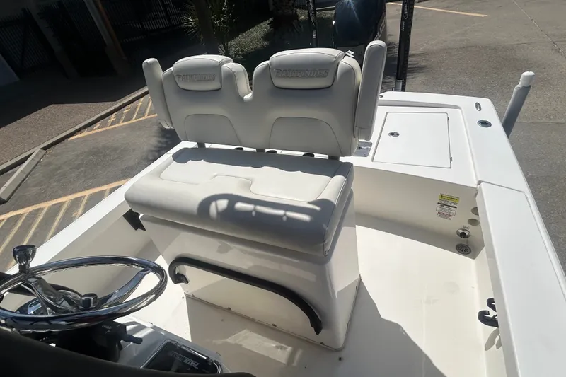 Slide: The Image of 2013 Pathfinder 2300 HPS boat interior with steering wheel and seating. - 14