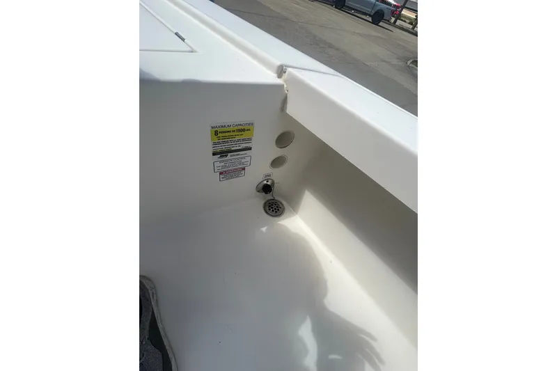 Slide: The Image of Interior view of a 2013 Pathfinder 2300 HPS boat showing capacity label and drainage area. - 15