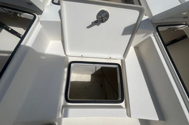 Slide: The Image of Open storage compartment on a 2013 Pathfinder 2300 HPS boat, showcasing interior space. - 7
