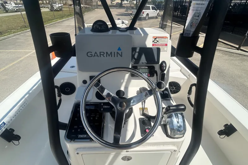 Slide: The Image of 2013 Pathfinder 2300 HPS boat console with Garmin navigation system and steering wheel. - 13
