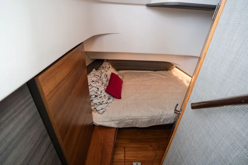 Slide: The Image of 2020 Tiara Sport 34 LS cabin interior with cozy bed and wooden accents. - 37