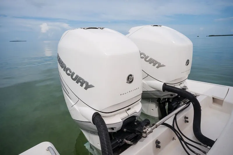 Slide: The Image of Twin Mercury outboard engines on a 2020 Tiara Sport 34 LS boat, calm sea background. - 20
