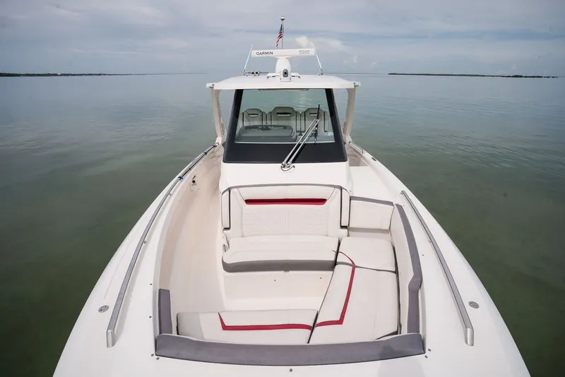 Slide: The Image of 2020 Tiara Sport 34 LS boat with spacious seating on calm water. - 31