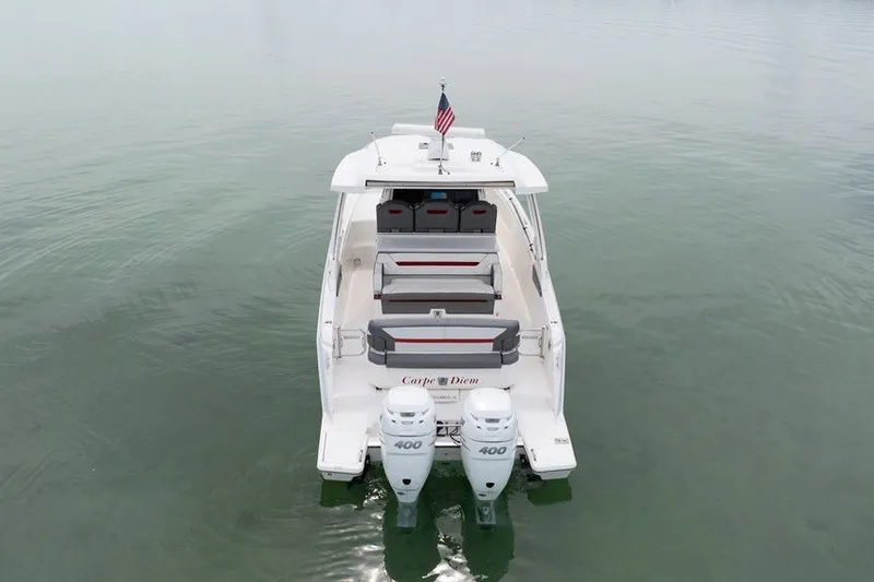 Slide: The Image of 2020 Tiara Sport 34 LS boat with twin 400 engines on calm water. - 15