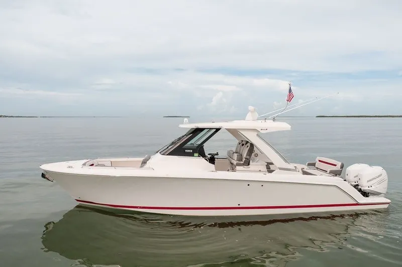 Slide: The Image of 2020 Tiara Sport 34 LS boat on calm water, side view. - 12