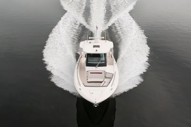 Slide: The Image of 2020 Tiara Sport 34 LS boat cruising on calm water, aerial view. - 9