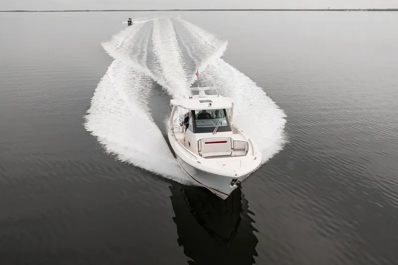 Slide: The Image of 2020 Tiara Sport 34 LS cruising on calm water, leaving a wake trail. - 10