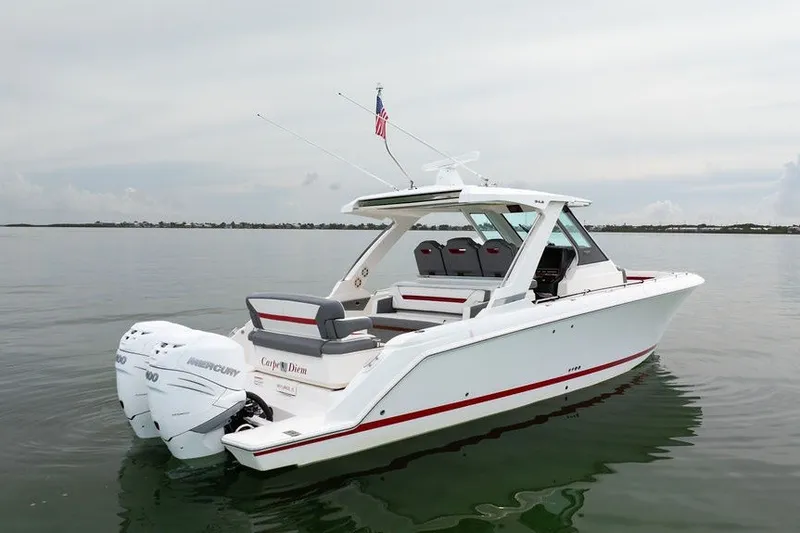 Slide: The Image of 2020 Tiara Sport 34 LS boat on calm water, featuring twin Mercury engines. - 1