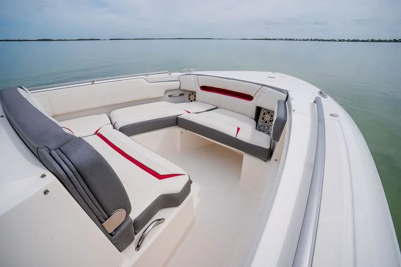 Slide: The Image of 2020 Tiara Sport 34 LS boat interior with cushioned seating on calm water. - 27