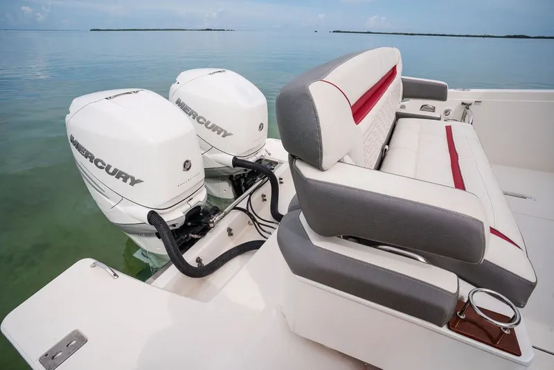 Slide: The Image of 2020 Tiara Sport 34 LS boat with dual Mercury outboard engines and cushioned seating. - 19