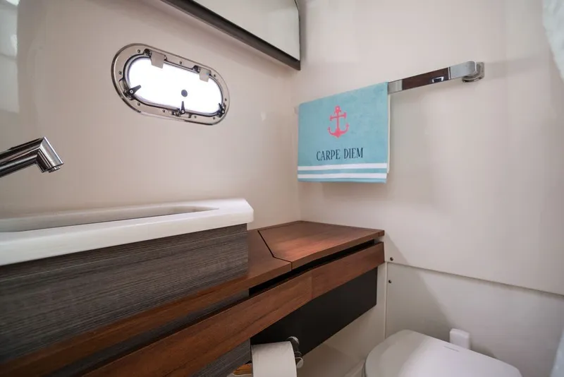 Slide: The Image of Luxurious 2020 Tiara Sport 34 LS yacht bathroom with modern sink and "Carpe Diem" towel. - 34