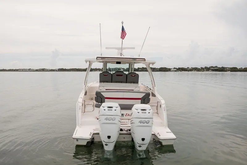 Slide: The Image of 2020 Tiara Sport 34 LS boat with dual 400 engines on calm water. - 14