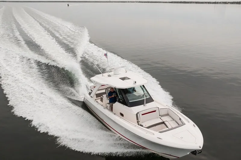 Slide: The Image of 2020 Tiara Sport 34 LS cruising on calm waters, leaving a wake behind. - 8