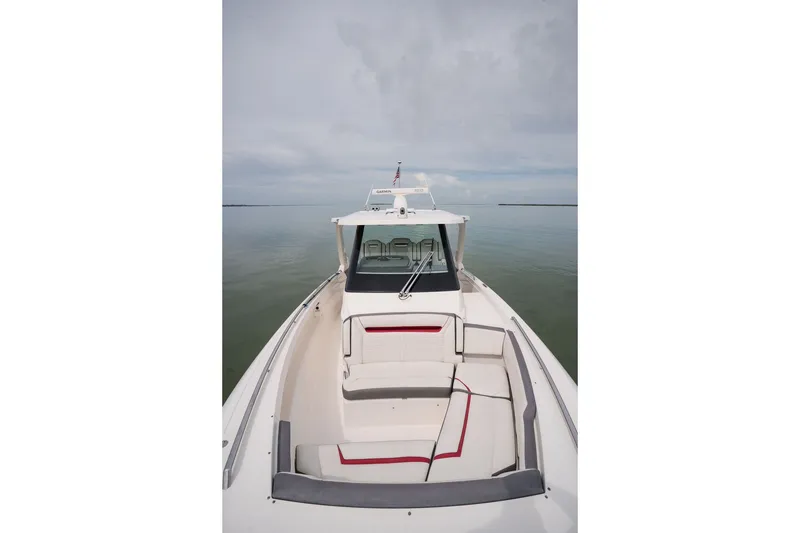Slide: The Image of 2020 Tiara Sport 34 LS boat on calm water, showcasing sleek design and spacious seating. - 30
