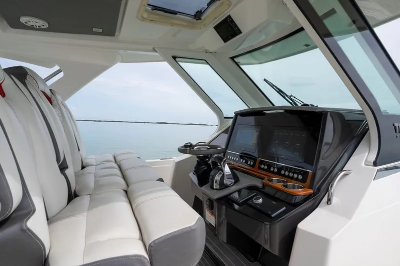 Slide: The Image of 2020 Tiara Sport 34 LS boat interior with modern dashboard and seating. - 25