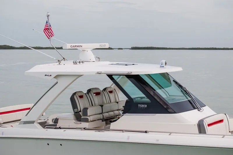 Slide: The Image of 2020 Tiara Sport 34 LS boat with Garmin radar, cruising on calm waters. - 13