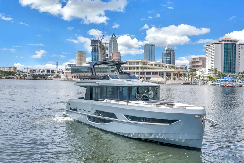 Slide: The Image of 2022 OKEAN 50 Flybridge yacht cruising in urban waterfront setting under blue skies. - 4