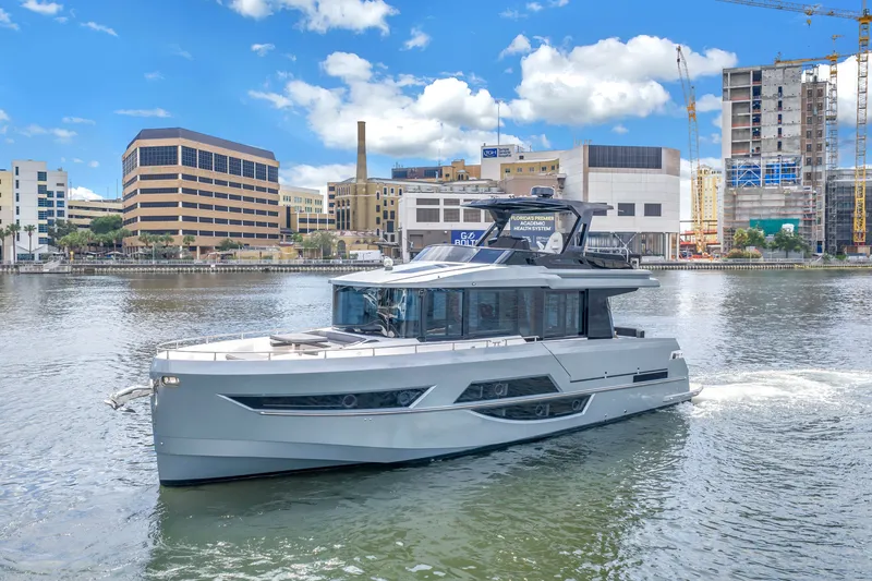 Slide: The Image of 2022 OKEAN 50 Flybridge yacht cruising in urban waterfront setting. - 1