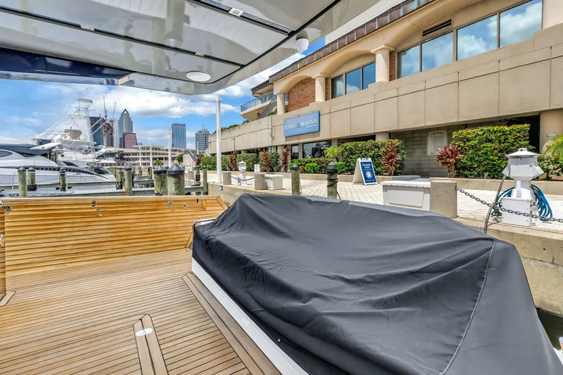 Slide: The Image of 2022 OKEAN 50 Flybridge yacht docked at a marina with city skyline view. - 95