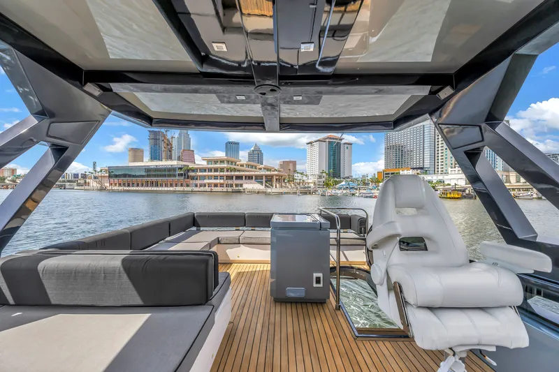 Slide: The Image of Flybridge view of 2022 OKEAN 50 yacht with city skyline in background. - 84