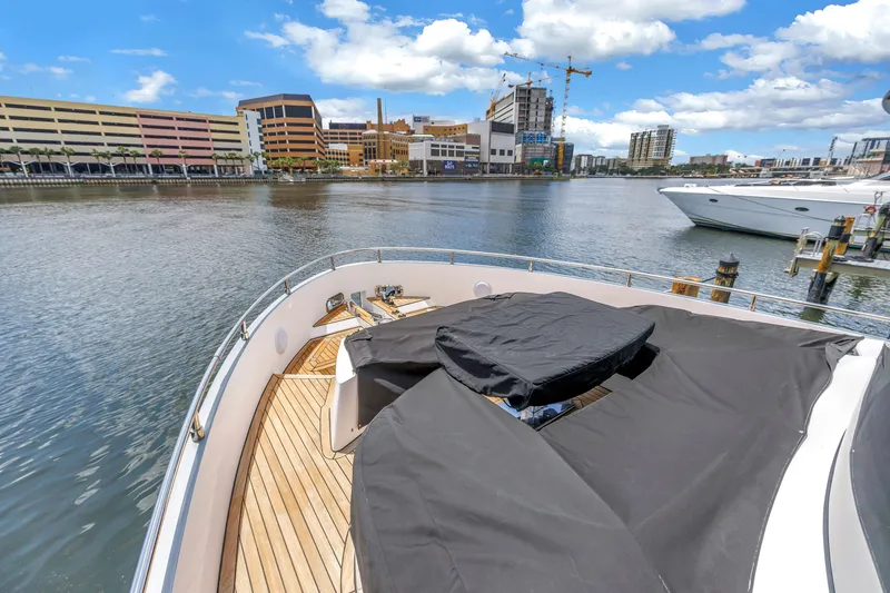 Slide: The Image of 2022 OKEAN 50 Flybridge yacht docked in urban marina with cityscape background. - 97