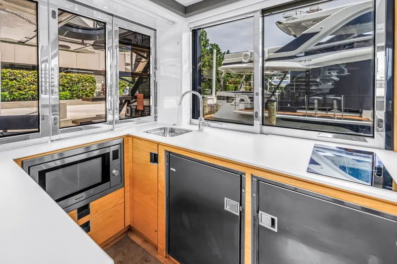 Slide: The Image of Modern kitchen interior of 2022 OKEAN 50 Flybridge yacht with sleek appliances and large windows. - 24