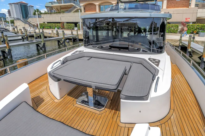 Slide: The Image of 2022 OKEAN 50 Flybridge yacht with sleek deck design and luxurious seating at marina. - 55